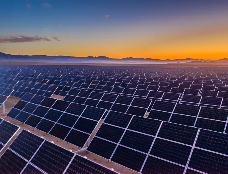 Une centrale solaire avec un champ de panneaux photovoltaïques inclinés. 